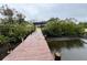 Long wooden dock leading to the water at 732 Riverside Dr, Tarpon Springs, FL 34689