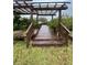 Wooden dock with pergola overhead at 732 Riverside Dr, Tarpon Springs, FL 34689