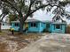 Charming light blue house with a well-maintained yard at 732 Riverside Dr, Tarpon Springs, FL 34689