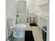 Well-lit laundry room, featuring washer, dryer, toilet, and sink at 732 Riverside Dr, Tarpon Springs, FL 34689