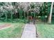 Landscaped backyard with gate and walkway at 3534 Player Dr, New Port Richey, FL 34655