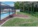 Backyard with grass, rock garden and pool at 3534 Player Dr, New Port Richey, FL 34655