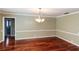 Dining room with hardwood floors and a stylish chandelier at 3534 Player Dr, New Port Richey, FL 34655