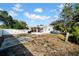 View of backyard showing grassy area, screened patio and a fence at 510 S Disston Ave, Tarpon Springs, FL 34689