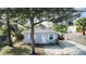 Gray house with a white trim, green lawn, and a driveway at 510 S Disston Ave, Tarpon Springs, FL 34689