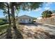 Quaint house with gray siding, a yard, and a long driveway at 510 S Disston Ave, Tarpon Springs, FL 34689