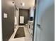 Modern bathroom with dark gray walls and white vanity at 750 N Tamiami Trl # 814, Sarasota, FL 34236