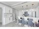 Contemporary white kitchen featuring marble countertops, modern appliances, and stylish pendant lighting at 750 N Tamiami Trl # 814, Sarasota, FL 34236