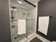 Modern shower with glass enclosure and pebble tile floor at 750 N Tamiami Trl # 814, Sarasota, FL 34236