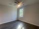 Bright bedroom with ceiling fan, hardwood floors, and large window at 1401 Newton St, Port Charlotte, FL 33952