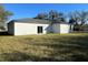 House exterior with sliding doors and grassy backyard at 1401 Newton St, Port Charlotte, FL 33952