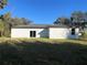 House exterior with sliding doors and grassy backyard at 1401 Newton St, Port Charlotte, FL 33952