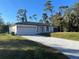 New construction home featuring a paved driveway and landscaped lawn at 1401 Newton St, Port Charlotte, FL 33952