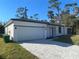 Modern single-story home with a paved driveway at 1401 Newton St, Port Charlotte, FL 33952