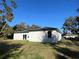 House exterior with sliding doors and grassy backyard at 1401 Newton St, Port Charlotte, FL 33952