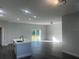 Bright and airy living room featuring dark gray vinyl flooring and sliding glass doors at 1401 Newton St, Port Charlotte, FL 33952