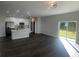 Open concept living area with dark gray vinyl flooring and natural light at 1401 Newton St, Port Charlotte, FL 33952