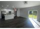 Open concept living area with dark gray vinyl flooring and natural light at 1401 Newton St, Port Charlotte, FL 33952