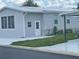 Gray single-wide manufactured home with carport at 3105 Beaver Creek Dr, Wesley Chapel, FL 33543