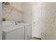 Laundry room with washer, dryer, and shelving at 3105 Beaver Creek Dr, Wesley Chapel, FL 33543