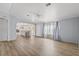 Spacious living room with light gray walls and wood-look flooring at 3105 Beaver Creek Dr, Wesley Chapel, FL 33543