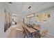 Dining room features a light wood table and rattan chairs at 3770 Torrey Pines Blvd, Sarasota, FL 34238