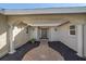 Covered entryway with arched columns and a dark brown door at 3770 Torrey Pines Blvd, Sarasota, FL 34238