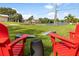 Relaxing backyard with red chairs and cornhole at 2917 Palm Dr, Punta Gorda, FL 33950