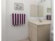 Small bathroom with beige vanity and mirror at 2917 Palm Dr, Punta Gorda, FL 33950