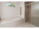 Bathroom with soaking tub, shower, and updated tile at 2917 Palm Dr, Punta Gorda, FL 33950