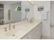 Double vanity bathroom with updated fixtures and large mirror at 2917 Palm Dr, Punta Gorda, FL 33950