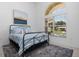 Bright bedroom with a metal bed frame and large window at 2917 Palm Dr, Punta Gorda, FL 33950