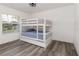 Bedroom with a white bunk bed and gray flooring at 2917 Palm Dr, Punta Gorda, FL 33950