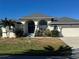 Single-story home with a gray roof, white walls, and a two-car garage at 2917 Palm Dr, Punta Gorda, FL 33950