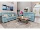 Relaxing living room featuring comfortable teal sofas and a wooden coffee table at 2917 Palm Dr, Punta Gorda, FL 33950