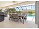 Outdoor dining area with seating for six, overlooking the pool at 2917 Palm Dr, Punta Gorda, FL 33950