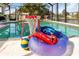 Inviting pool area with basketball hoop and floaties at 2917 Palm Dr, Punta Gorda, FL 33950