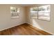 Bright bedroom with wood-look floors and large windows at 4215 Pecos Dr, New Port Richey, FL 34653