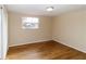 Simple bedroom with wood-look floors and a window at 4215 Pecos Dr, New Port Richey, FL 34653