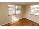 Spacious bedroom featuring wood-look floors and multiple windows at 4215 Pecos Dr, New Port Richey, FL 34653