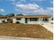 Newly renovated home with teal door and landscaping at 4215 Pecos Dr, New Port Richey, FL 34653