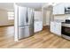 Stainless steel refrigerator and white kitchen cabinets at 4215 Pecos Dr, New Port Richey, FL 34653