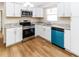 Kitchen with white cabinets, granite counters, and stainless steel appliances at 4215 Pecos Dr, New Port Richey, FL 34653