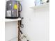 Small laundry room with water heater and shelving at 4215 Pecos Dr, New Port Richey, FL 34653