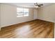 Bright living room with wood-look floors and a view of the street at 4215 Pecos Dr, New Port Richey, FL 34653
