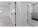 Hall bathroom with white tiled floors and doors to bedrooms at 4401 Shore Acres Ne Blvd, St Petersburg, FL 33703