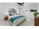 Main bedroom with ceiling fan, large bed, and stylish decor at 4401 Shore Acres Ne Blvd, St Petersburg, FL 33703