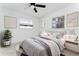 Bedroom with ceiling fan, windows, and neutral decor at 4401 Shore Acres Ne Blvd, St Petersburg, FL 33703