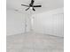 Bedroom with ceiling fan, double door closet, and tile flooring at 4401 Shore Acres Ne Blvd, St Petersburg, FL 33703