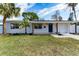 Updated home exterior, featuring a new coat of paint and landscaping at 4401 Shore Acres Ne Blvd, St Petersburg, FL 33703